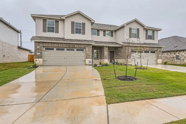 a front view of a house with a yard