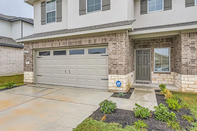 a front view of a house with a yard