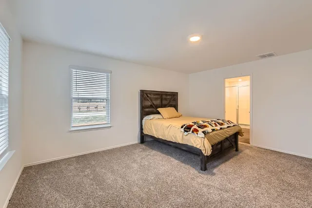 a bedroom with a bed and window