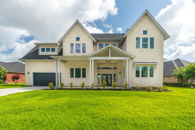 a front view of a house with a yard and garage