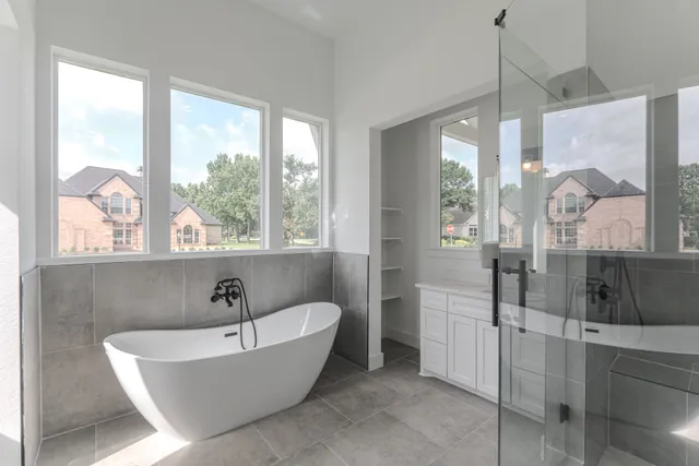 a bathroom with a granite countertop sink a mirror and a bathtub
