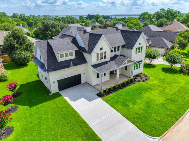 an aerial view of a house with a big yard