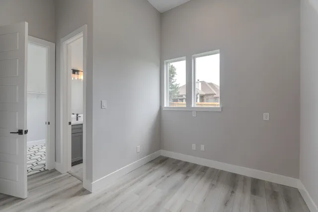 a bathroom with a granite countertop sink toilet a mirror and window