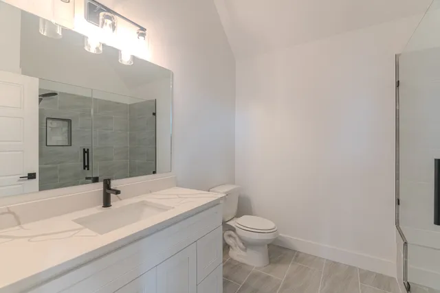 an empty room with a window and a mirror