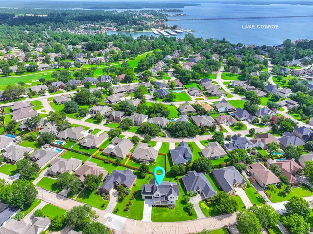 a view of a house with a big yard and large trees