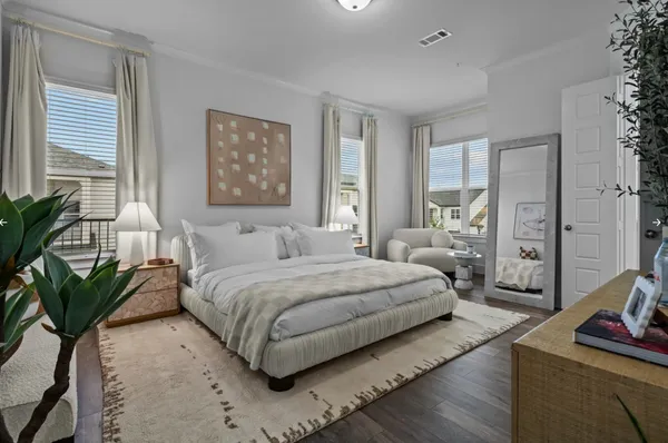 a bedroom with bed and a potted plant