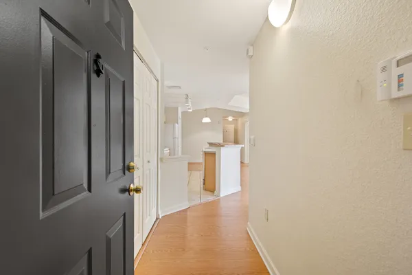 a view of a hallway with wooden shelves