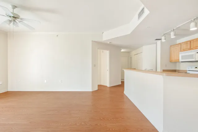 a view of a kitchen with a sink and a refrigerator