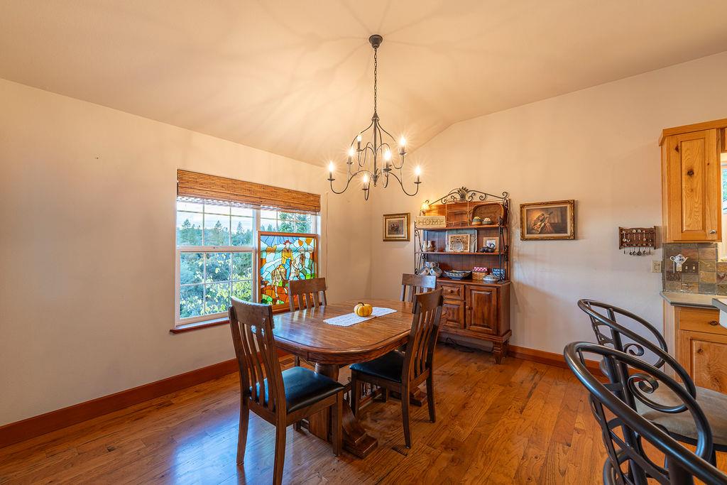 10132 Ranch Road Rough and Ready, CA 95975 - Photo 11 of 54 a view of a dining room with furniture window and wooden floor