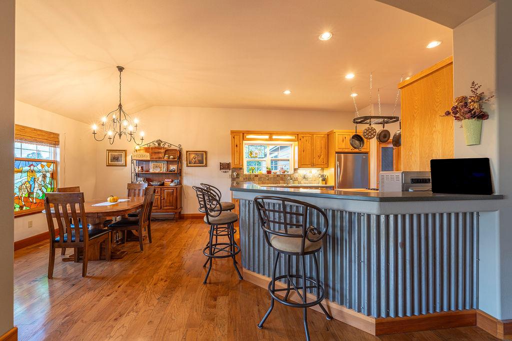 10132 Ranch Road Rough and Ready, CA 95975 - Photo 20 of 54 a dining room with furniture window and wooden floor