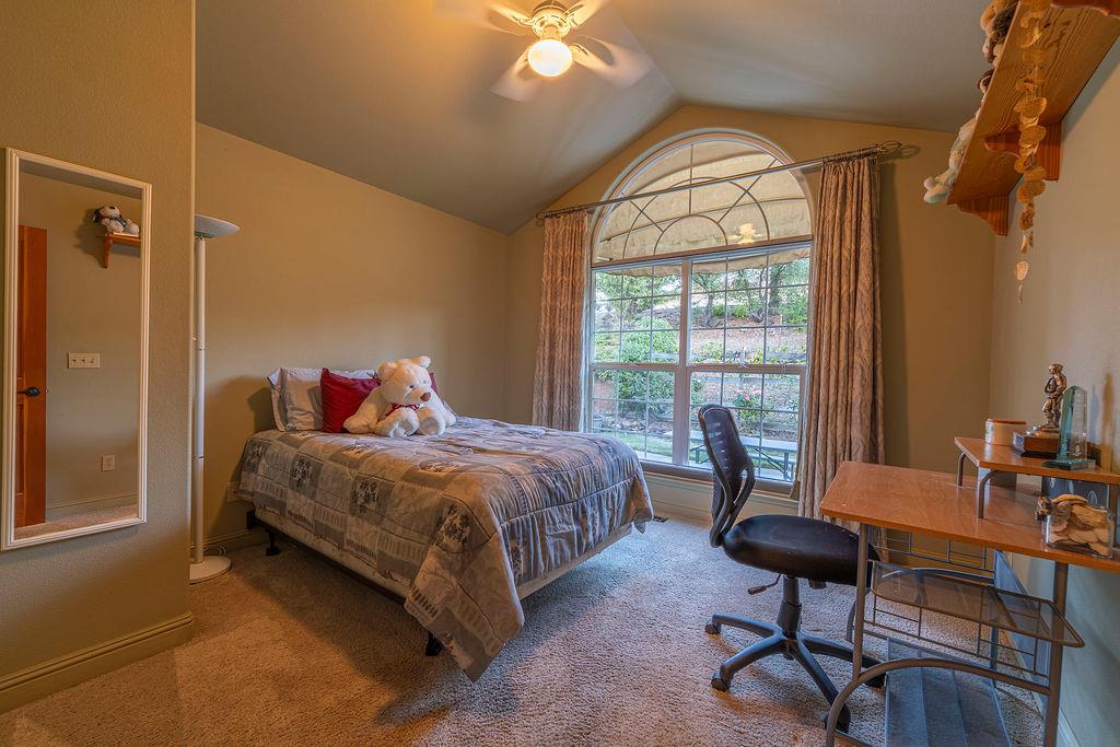 10132 Ranch Road Rough and Ready, CA 95975 - Photo 27 of 54 a bedroom with a bed and a chandelier