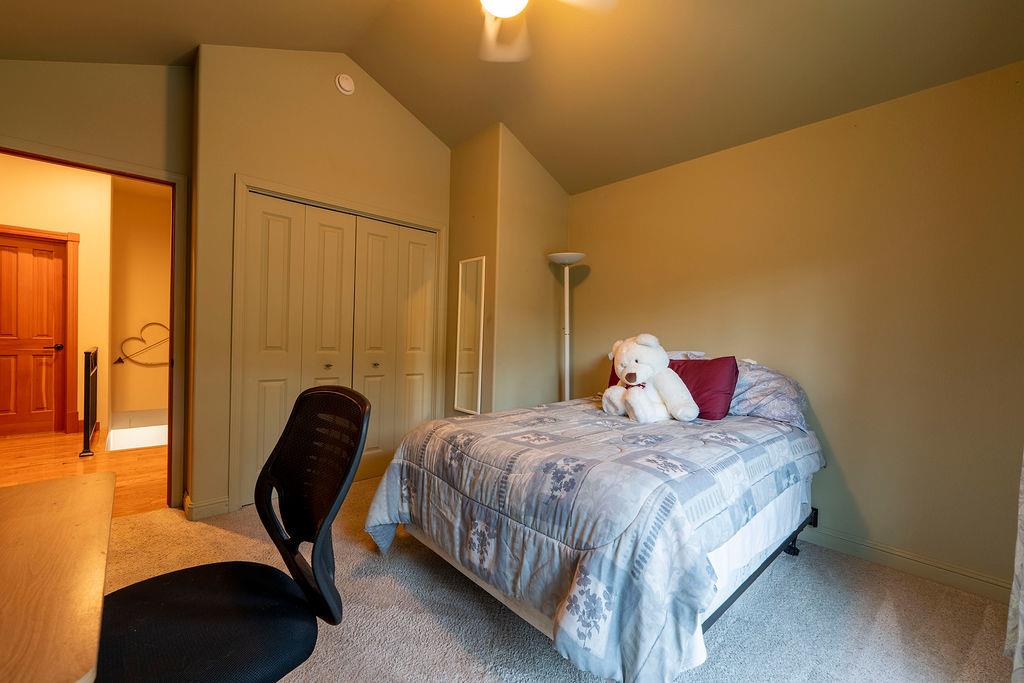 10132 Ranch Road Rough and Ready, CA 95975 - Photo 28 of 54 a bedroom with a bed chair and a large window