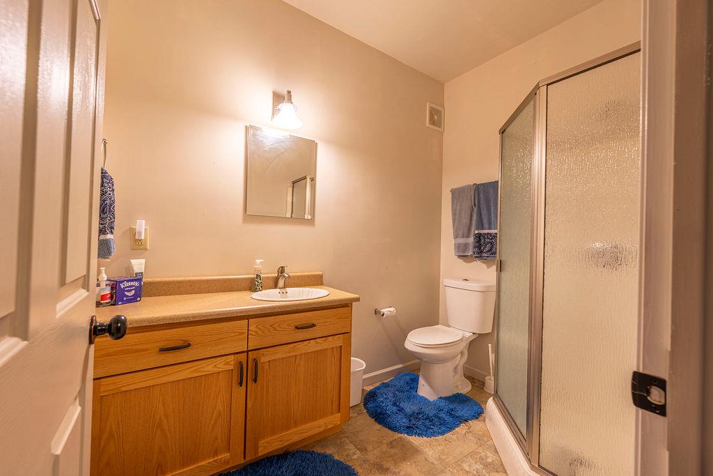 10132 Ranch Road Rough and Ready, CA 95975 - Photo 37 of 54 a bathroom with a sink a toilet and shower