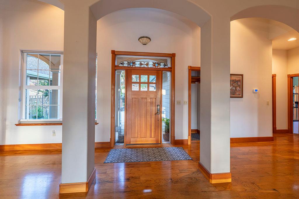 10132 Ranch Road Rough and Ready, CA 95975 - Photo 9 of 54 a view of a hallway with wooden floor and a living room