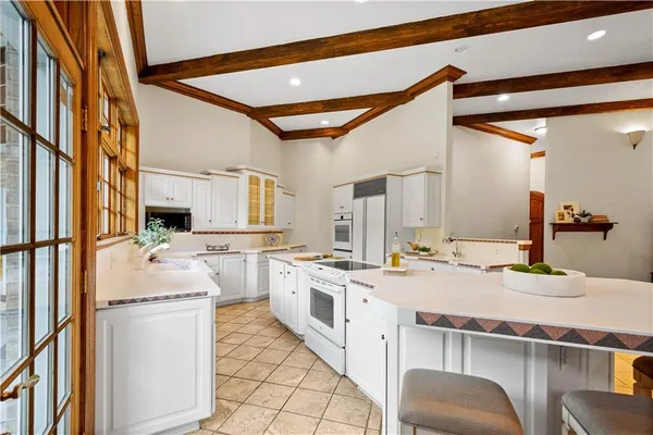 a kitchen with a sink stove and cabinets
