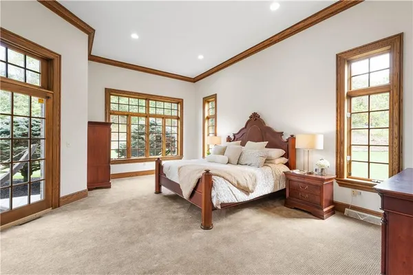 a spacious bedroom with a bed and a large window