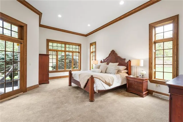 a spacious bedroom with a bed and a large window