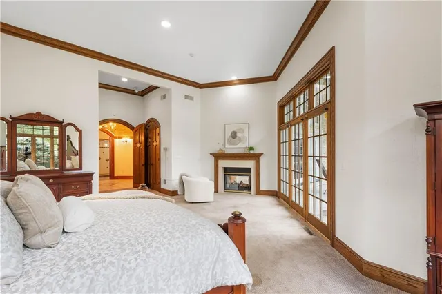 a bedroom with furniture and a large window