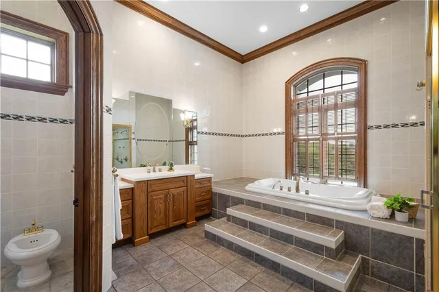 a spacious bathroom with a double vanity sink toilet and a mirror