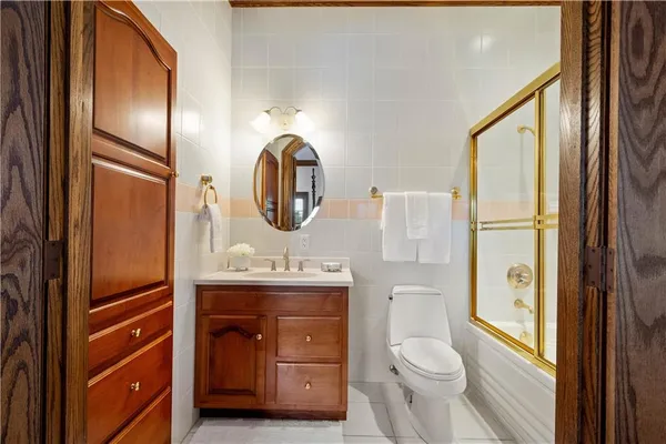 a bathroom with a toilet a sink and mirror