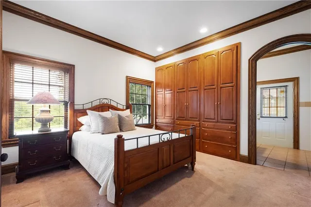 a bedroom with a bed lamp and window