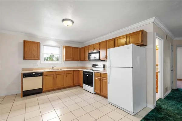 a kitchen with a refrigerator sink and stove