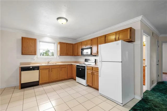 a kitchen with a refrigerator sink and stove