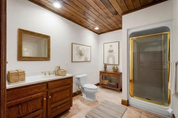a spacious bathroom with a double vanity sink a large mirror and a shower
