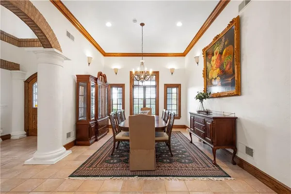 a dining room with wooden floor and stainless steel appliances
