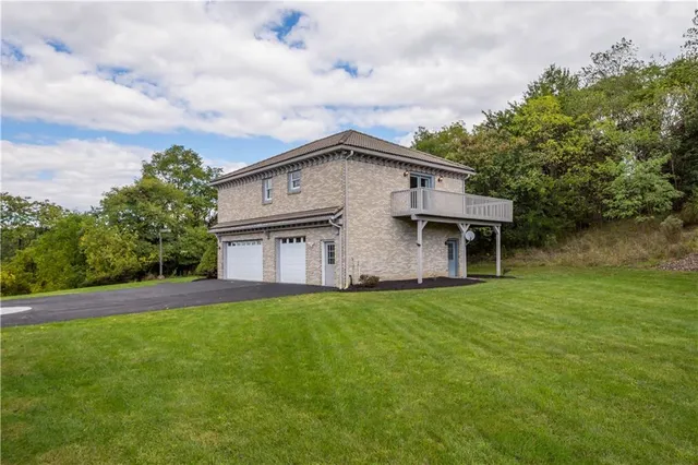 a house that has a big yard and large trees