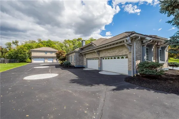 a view of a house with a yard and garage
