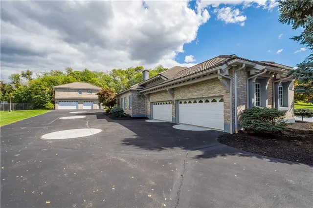 a view of a house with a yard and garage