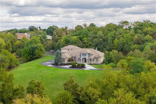a view of a house with a yard and sitting area