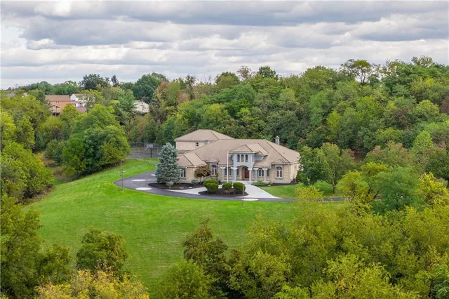 a view of a house with a yard and sitting area