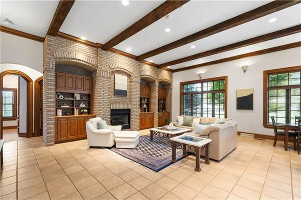 a living room with patio furniture and a fireplace