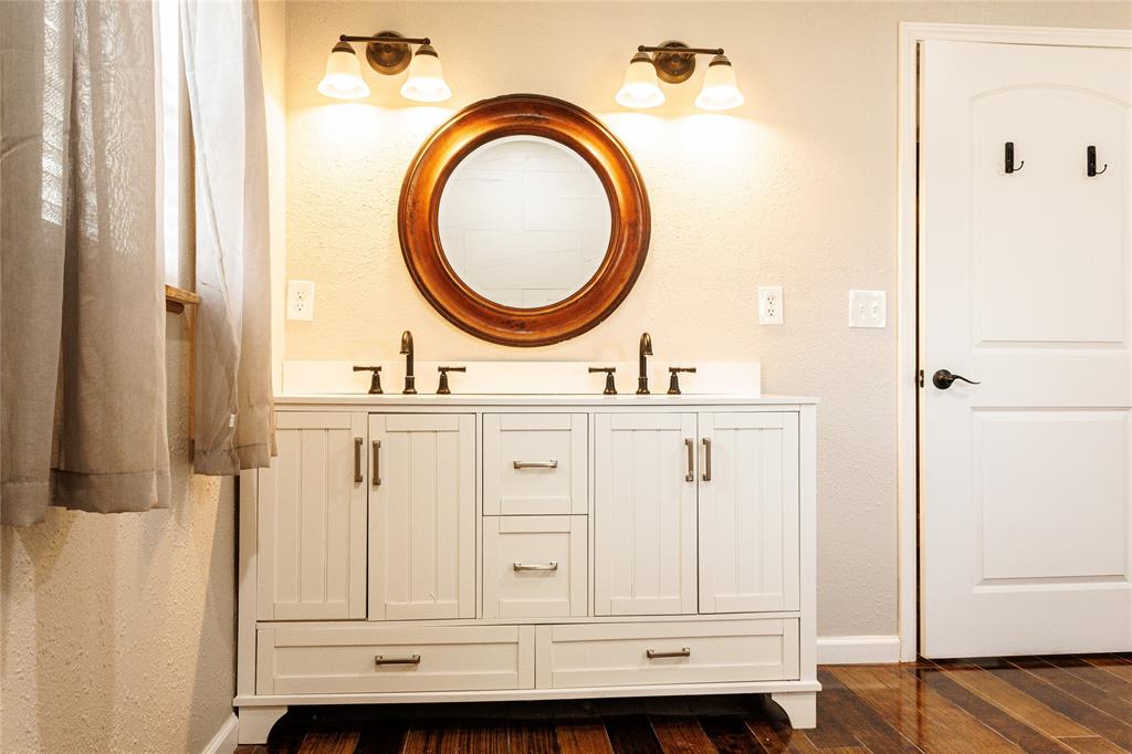 103 County Road Comanche, TX 76442 - Photo 18 of 37 a bathroom with a sink a vanity and a mirror