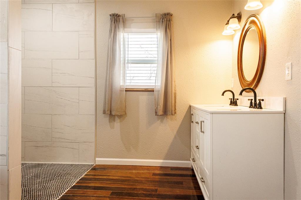 103 County Road Comanche, TX 76442 - Photo 19 of 37 a bathroom with a sink a toilet and a mirror