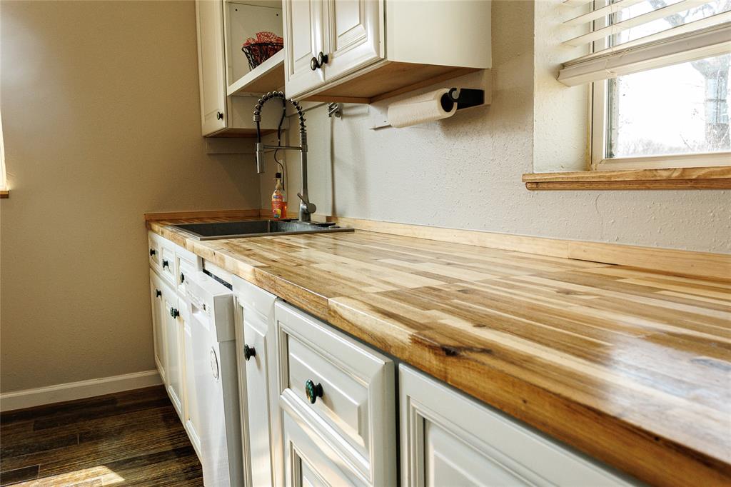 103 County Road Comanche, TX 76442 - Photo 23 of 37 a kitchen with a stove and a white cabinet