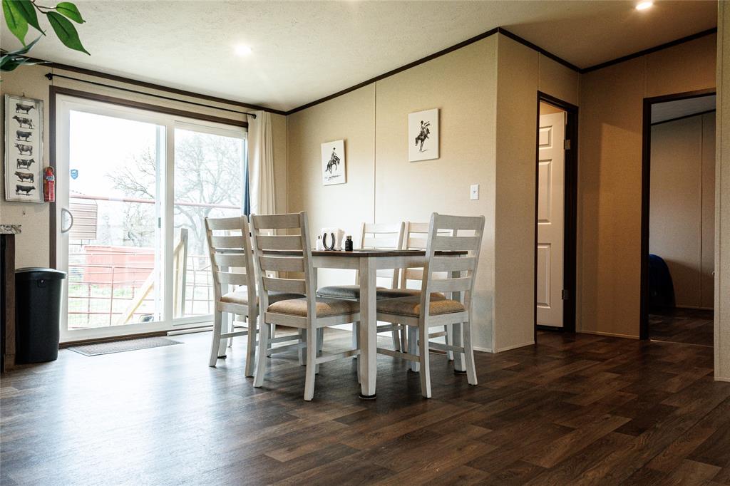 103 County Road Comanche, TX 76442 - Photo 36 of 37 a view of a dining room with furniture and wooden floor