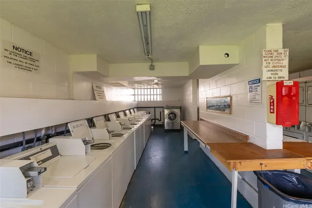 a kitchen with stainless steel appliances kitchen island granite countertop a sink and a stove