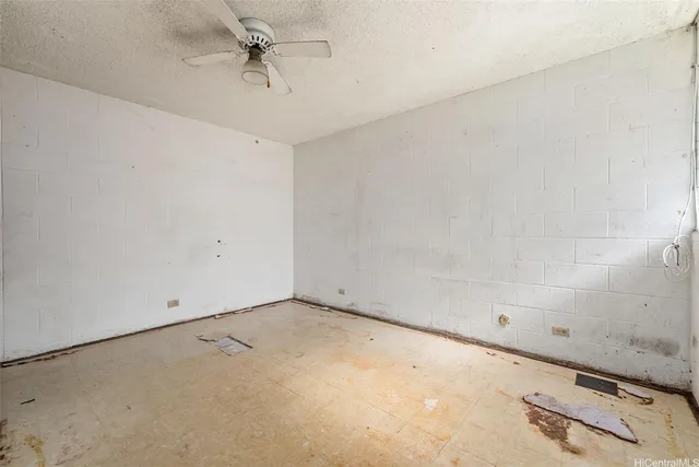 an empty room with a ceiling fan