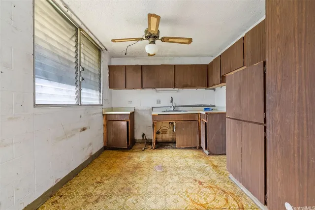 a kitchen with a refrigerator sink and cabinets