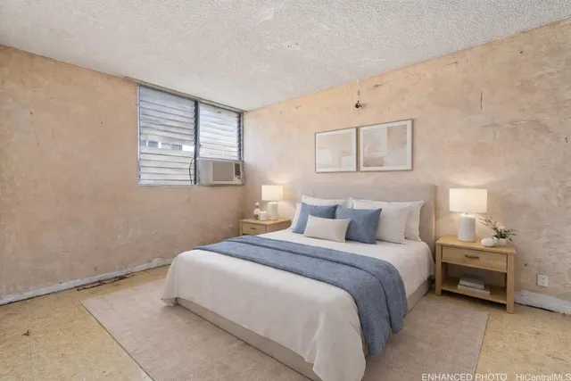 a bedroom with a bed and a window