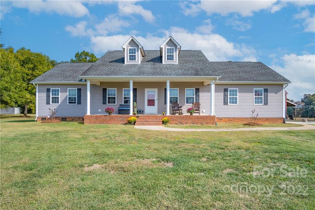 6925 Medlin Road Monroe, NC 28112 - Photo 1 of 41 a front view of a house with swimming pool having outdoor seating