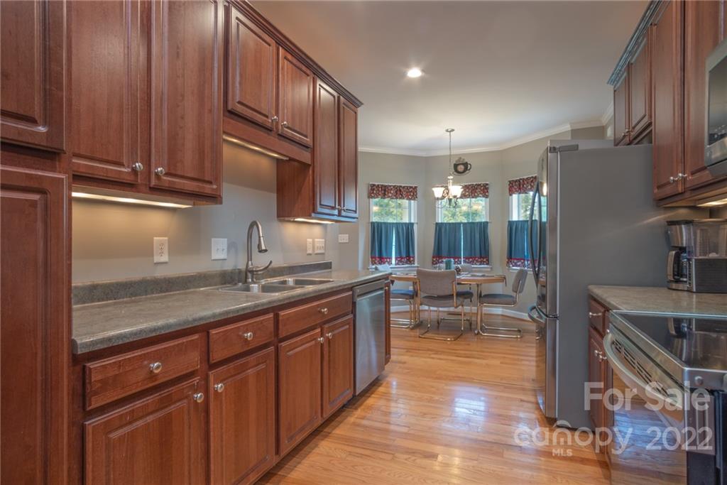 6925 Medlin Road Monroe, NC 28112 - Photo 13 of 41 a kitchen with counter top space and cabinets
