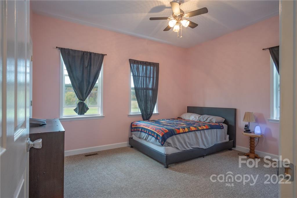 6925 Medlin Road Monroe, NC 28112 - Photo 15 of 41 a bedroom with a bed and a window