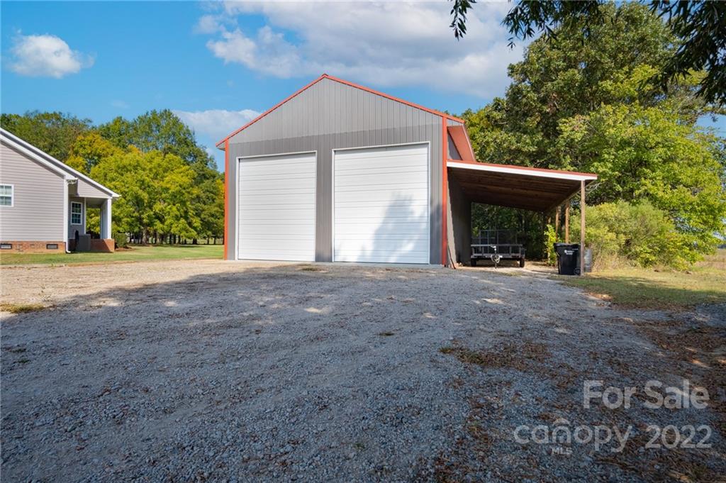 6925 Medlin Road Monroe, NC 28112 - Photo 20 of 41 a view of an house with backyard and a garden