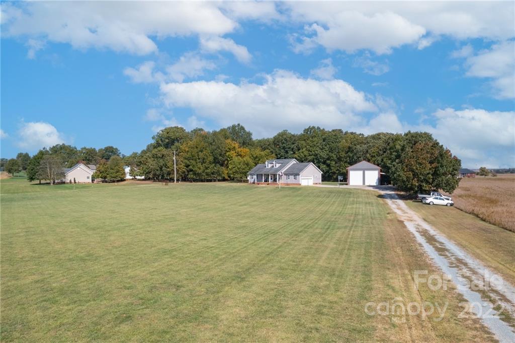 6925 Medlin Road Monroe, NC 28112 - Photo 29 of 41 a view of yard with swimming pool and trees in the background