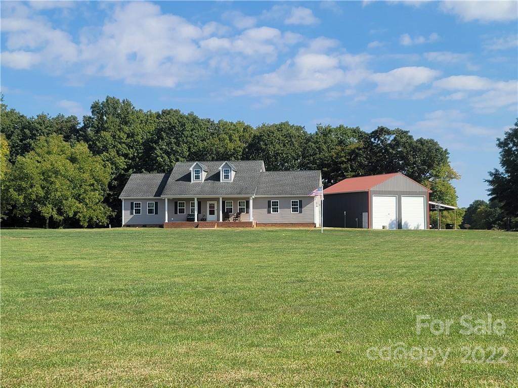 6925 Medlin Road Monroe, NC 28112 - Photo 34 of 41 a view of a big house with a big yard and large trees