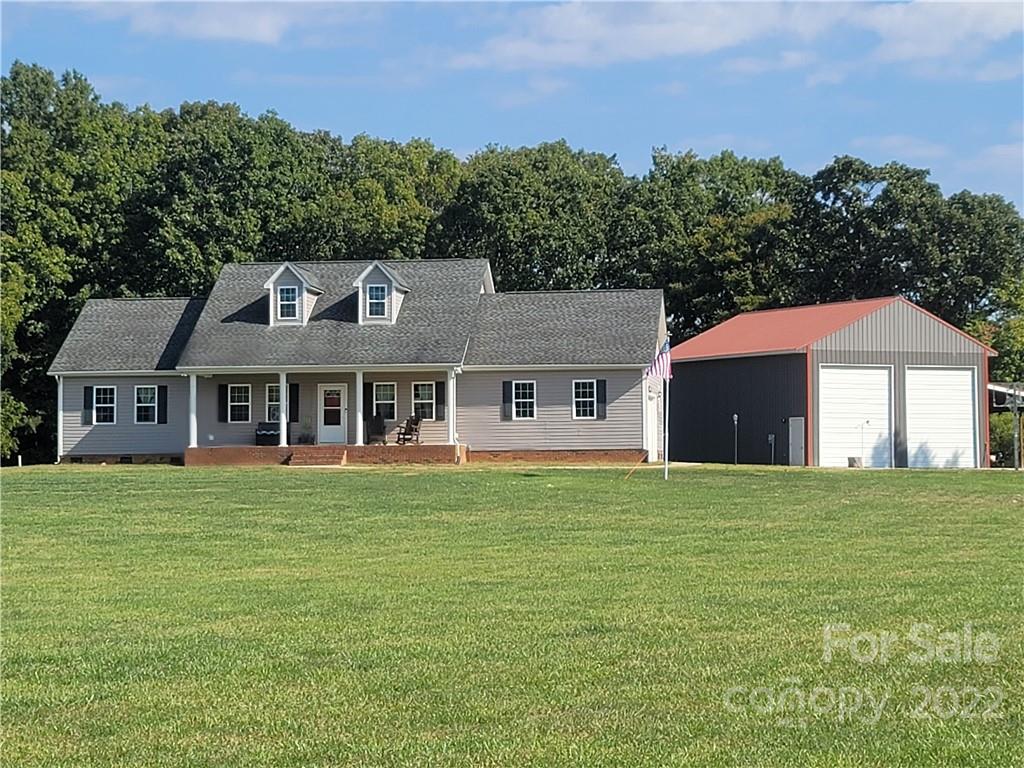 6925 Medlin Road Monroe, NC 28112 - Photo 36 of 41 a front view of a house with a garden